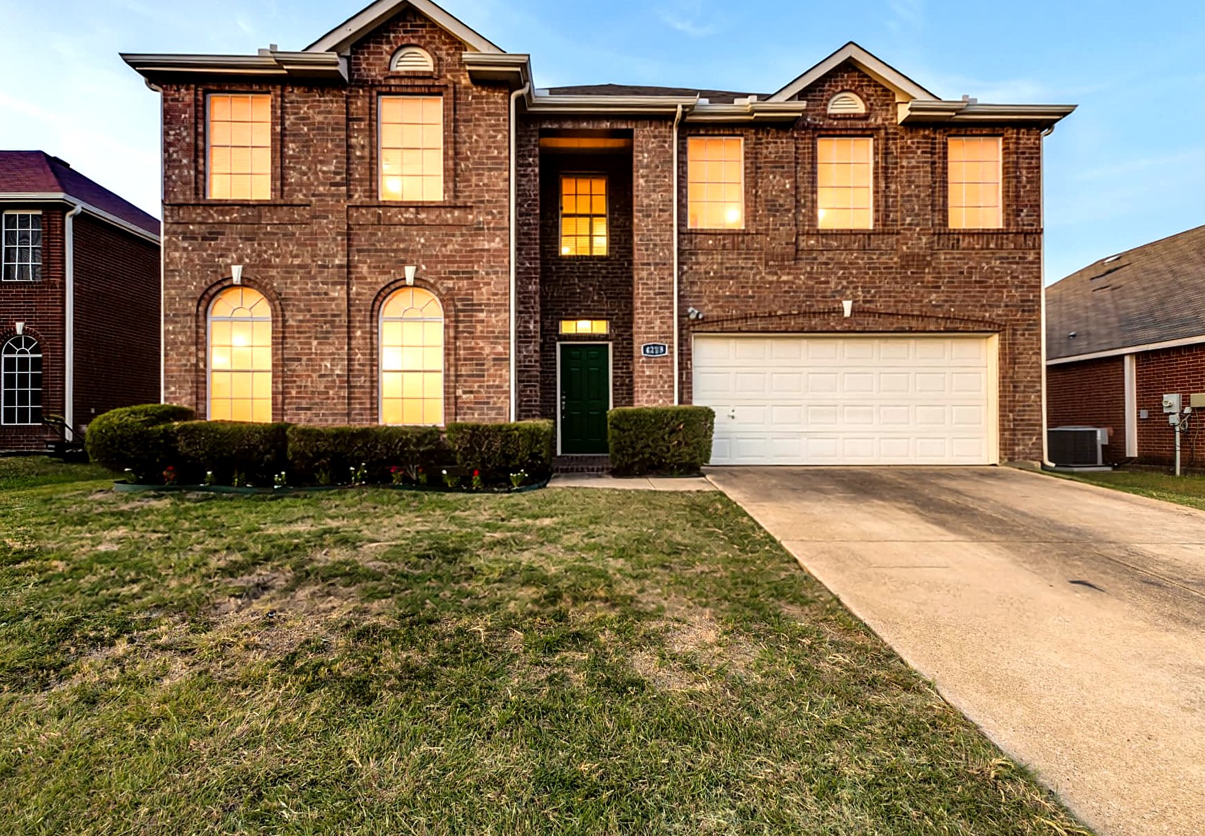 Exterior view of 4215 Maidstone Drive, a two-story brick residence in Garland, Texas.